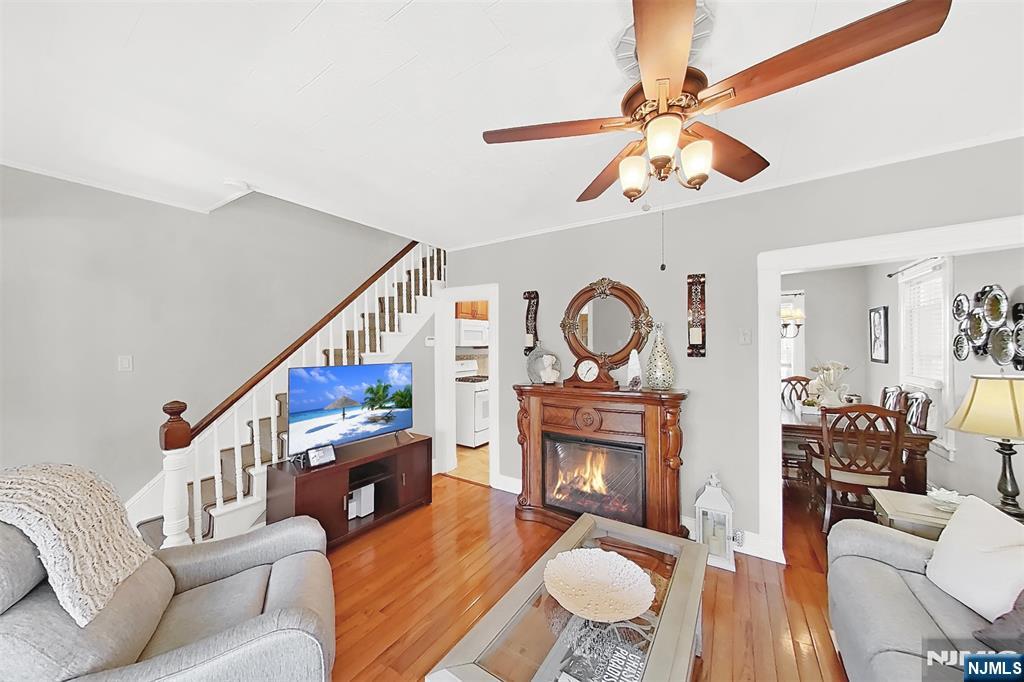 438 Forest Street Kearny, NJ 07032 - Photo 17 of 38 a living room with furniture a fireplace and a ceiling fan