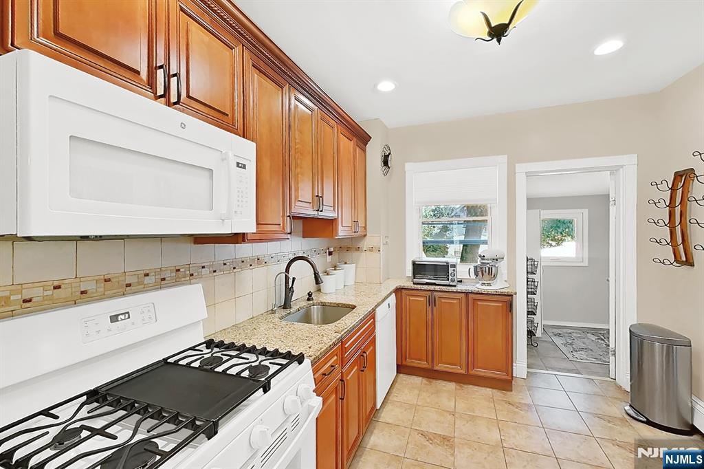 438 Forest Street Kearny, NJ 07032 - Photo 23 of 38 a kitchen with a sink stove top oven and cabinets
