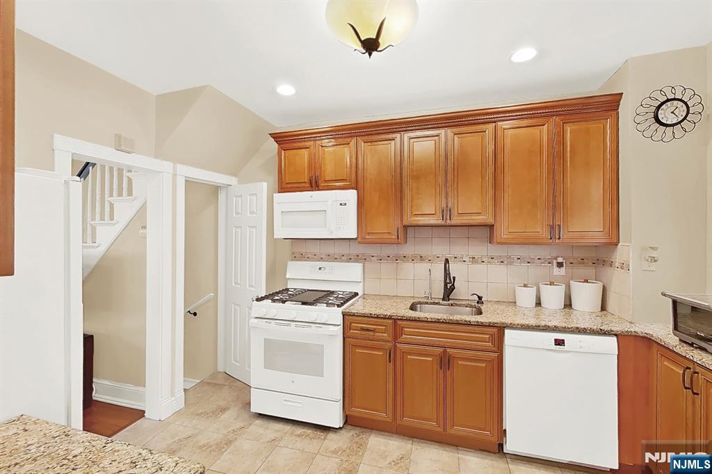 438 Forest Street Kearny, NJ 07032 - Photo 25 of 38 a kitchen with a stove a sink and a refrigerator