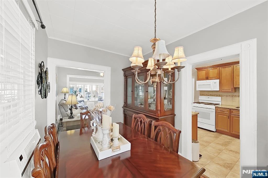 438 Forest Street Kearny, NJ 07032 - Photo 27 of 38 a view of a dining room with furniture a chandelier and wooden floor