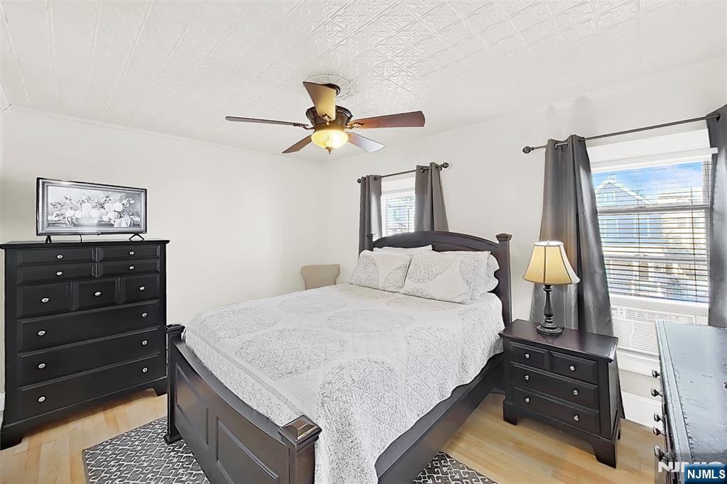 438 Forest Street Kearny, NJ 07032 - Photo 28 of 38 a bedroom with a bed and a dresser