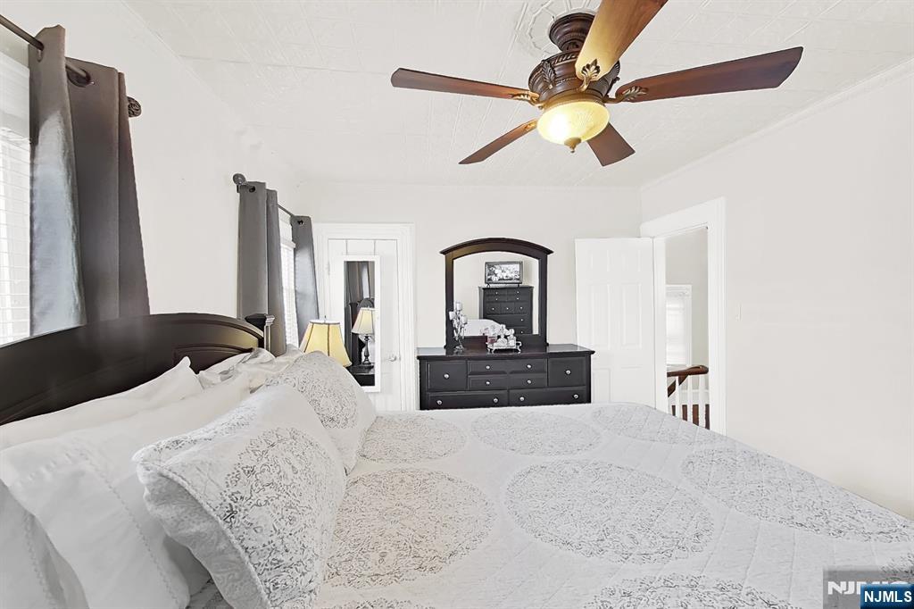 438 Forest Street Kearny, NJ 07032 - Photo 30 of 38 a bedroom with a large bed and a chandelier