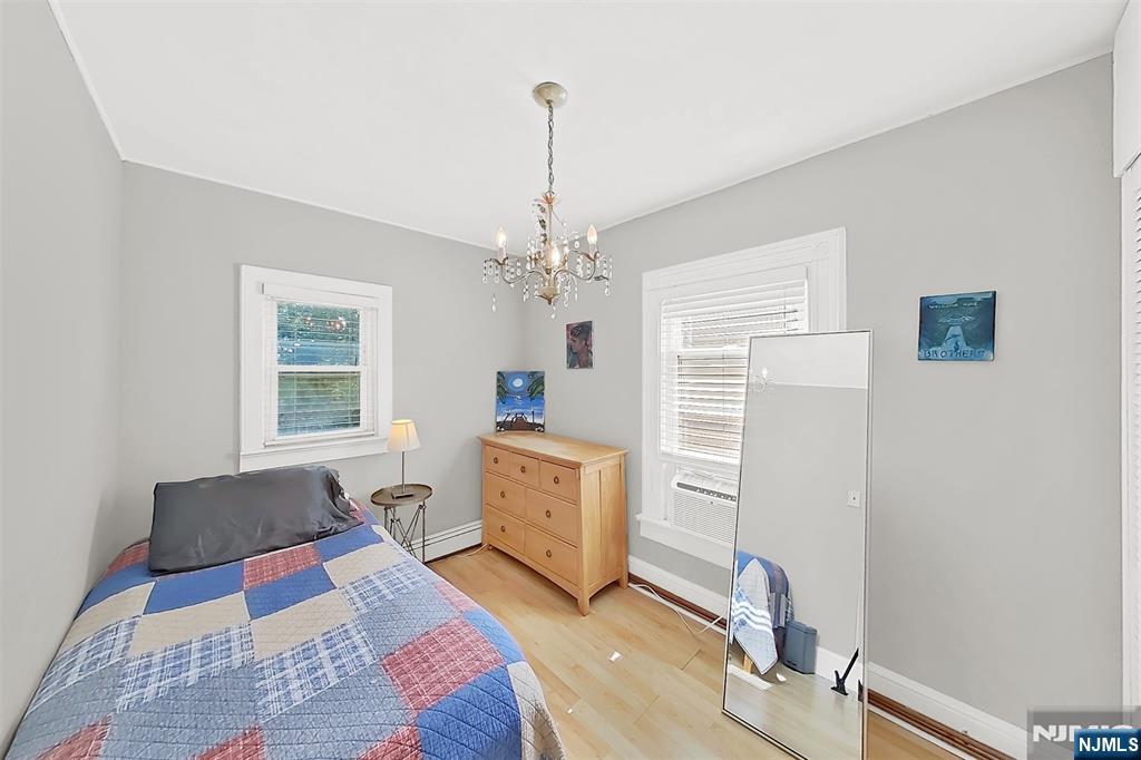 438 Forest Street Kearny, NJ 07032 - Photo 32 of 38 a living room with furniture and a chandelier