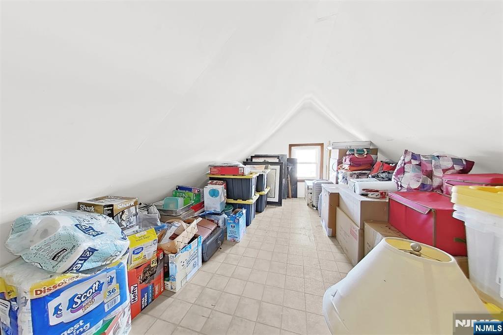 438 Forest Street Kearny, NJ 07032 - Photo 33 of 38 a utility room with toys and a chandelier