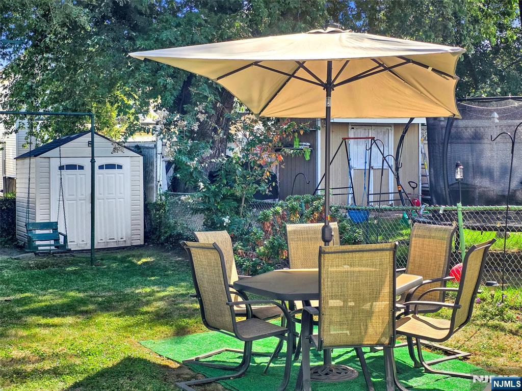 438 Forest Street Kearny, NJ 07032 - Photo 6 of 38 a view of backyard of house with seating space and swimming pool