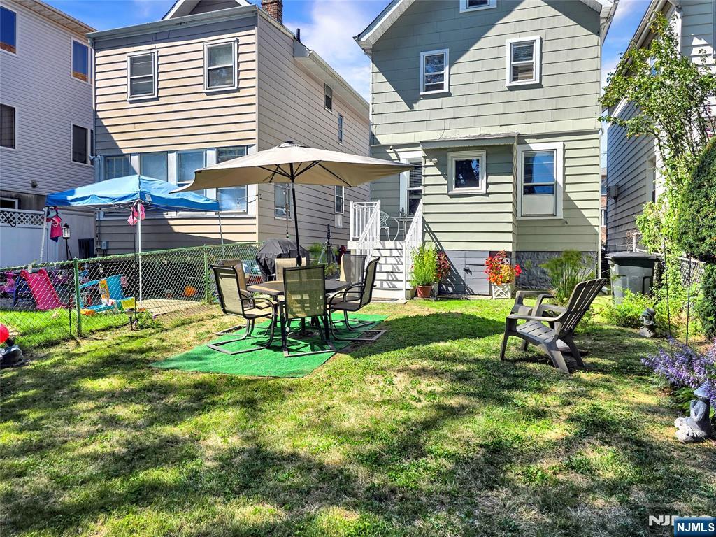 438 Forest Street Kearny, NJ 07032 - Photo 10 of 38 a view of a chair and table in backyard of the house