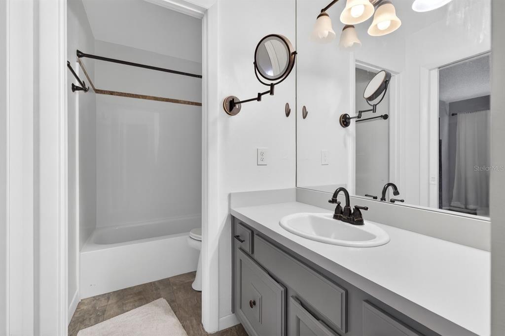 6525 Cape Sable Way Northeast, Unit 2 St. Petersburg, FL 33702 - Photo 11 of 26 a bathroom with a sink and a mirror