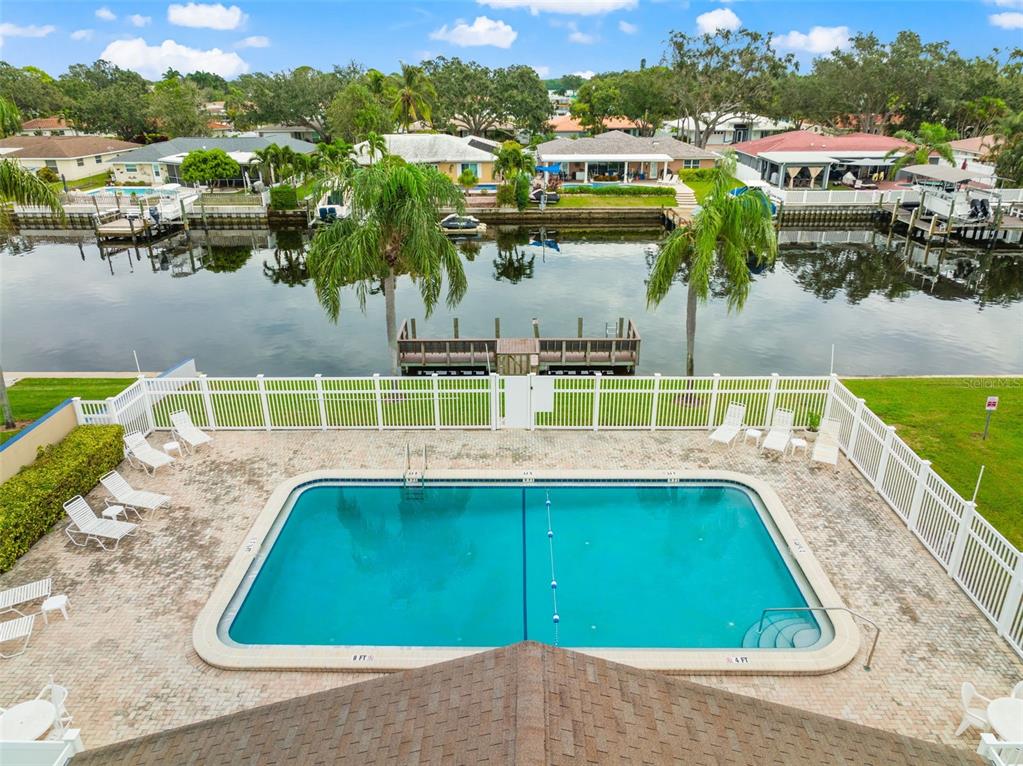 6525 Cape Sable Way Northeast, Unit 2 St. Petersburg, FL 33702 - Photo 25 of 26 a view of swimming pool with outdoor seating and yard in the back