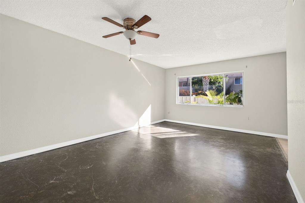 6525 Cape Sable Way Northeast, Unit 2 St. Petersburg, FL 33702 - Photo 5 of 26 an empty room with wooden floor and windows