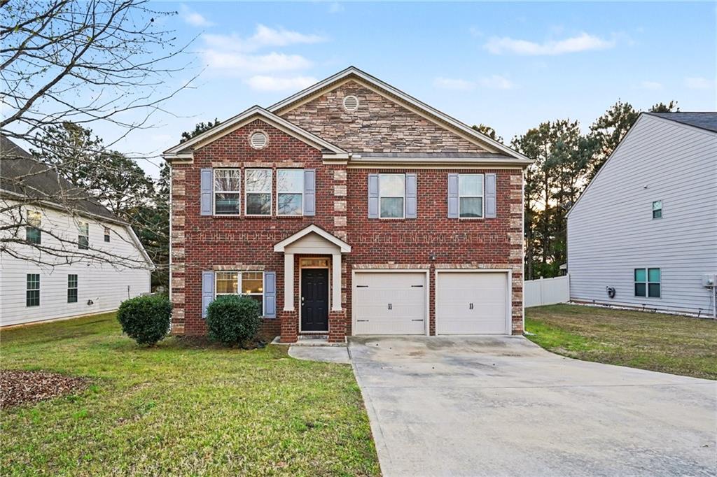 1241 England Terrace Hampton, GA 30228 - Photo 1 of 20 a front view of a house with a garden and plants