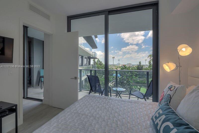 121 Northeast 34th Street, Unit 814 Miami, FL 33137 - Photo 14 of 38 a living room with furniture and a floor to ceiling window