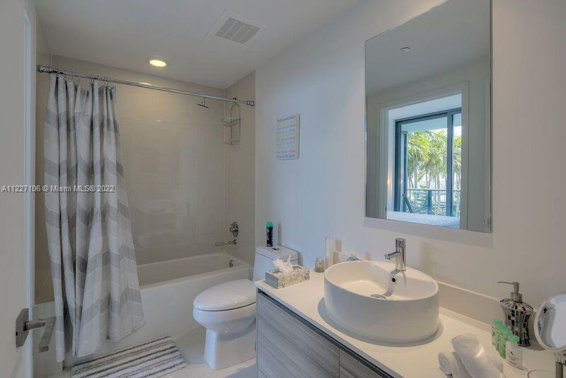 121 Northeast 34th Street, Unit 814 Miami, FL 33137 - Photo 15 of 38 a bathroom with a sink toilet and shower