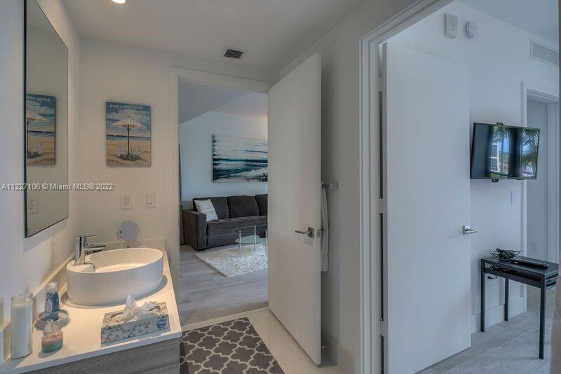 121 Northeast 34th Street, Unit 814 Miami, FL 33137 - Photo 16 of 38 a bathroom with a sink and a mirror