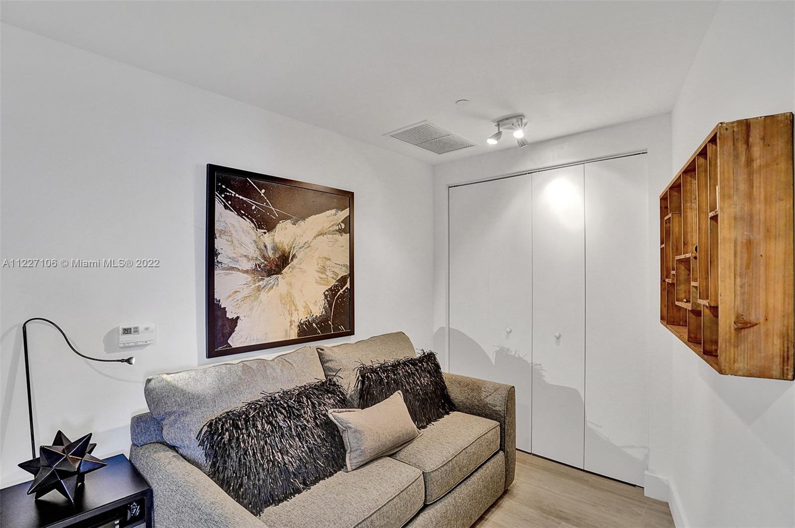 121 Northeast 34th Street, Unit 814 Miami, FL 33137 - Photo 24 of 38 a living room with furniture and a painting