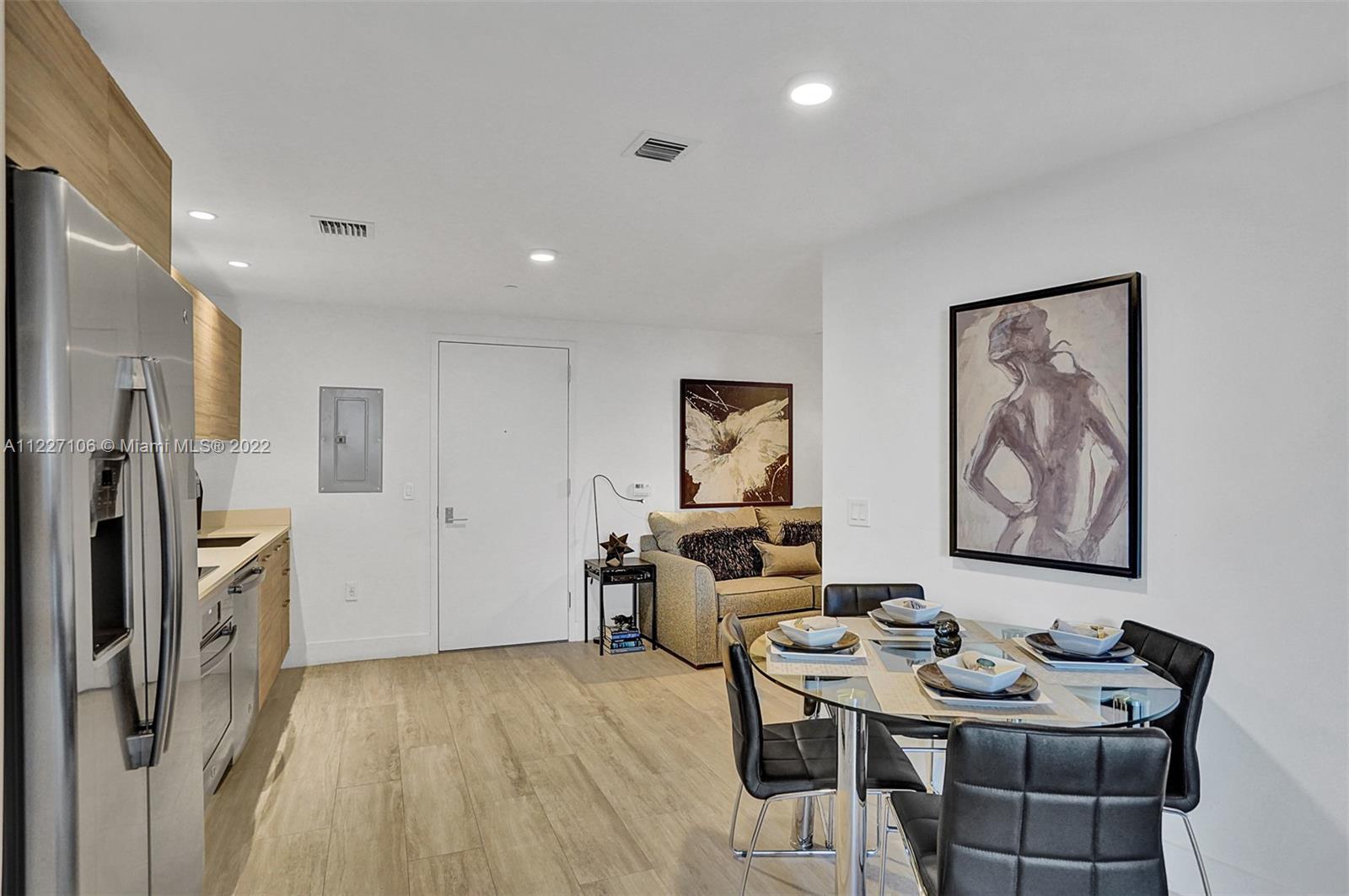 121 Northeast 34th Street, Unit 814 Miami, FL 33137 - Photo 27 of 38 a view of a dining room with furniture
