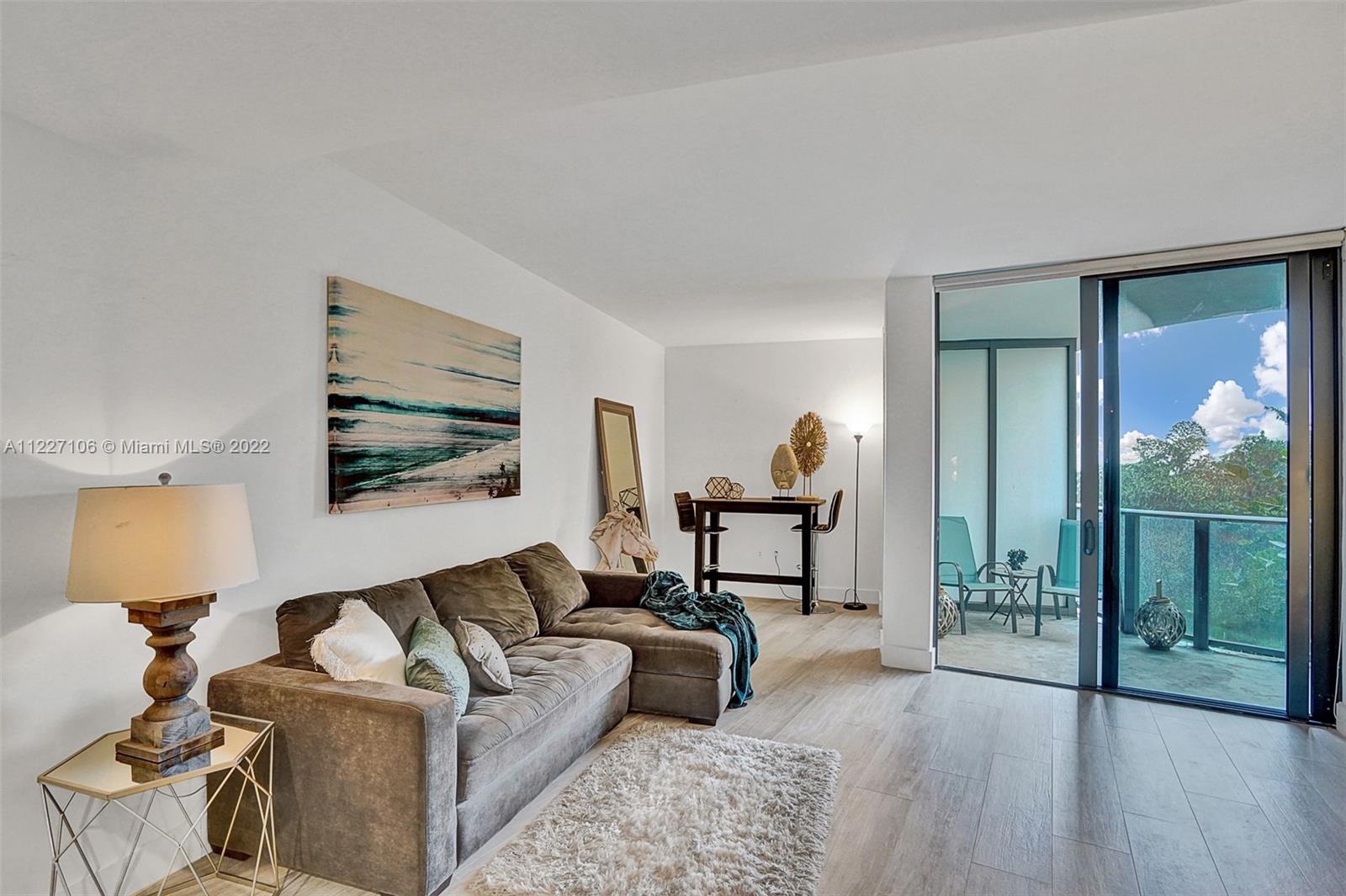 121 Northeast 34th Street, Unit 814 Miami, FL 33137 - Photo 29 of 38 a living room with furniture and a window