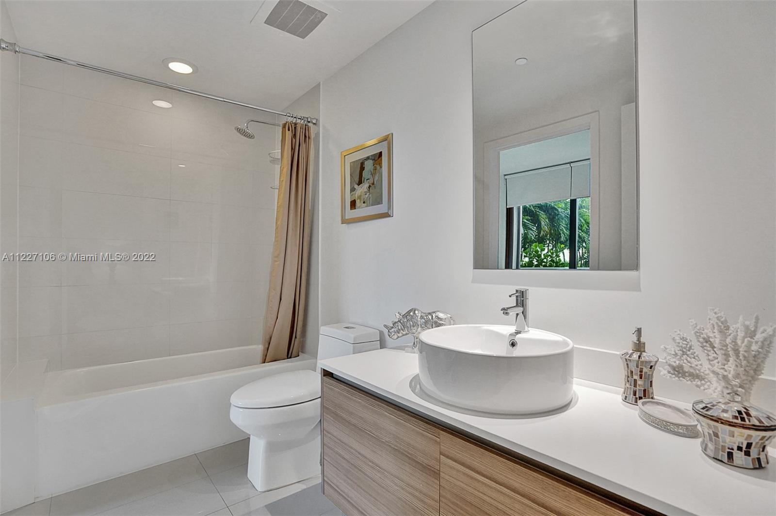 121 Northeast 34th Street, Unit 814 Miami, FL 33137 - Photo 34 of 38 a bathroom with a sink and a mirror