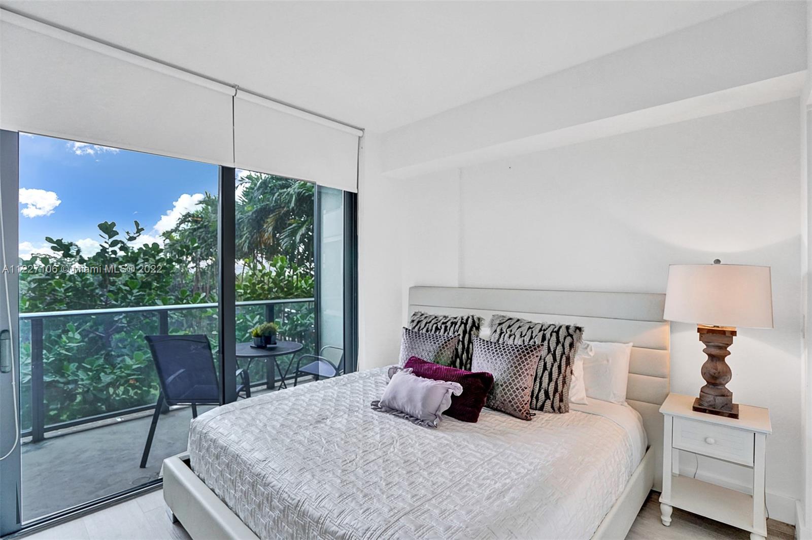 121 Northeast 34th Street, Unit 814 Miami, FL 33137 - Photo 36 of 38 a bedroom with a bed and a window