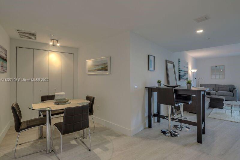 121 Northeast 34th Street, Unit 814 Miami, FL 33137 - Photo 4 of 38 a view of a workspace with furniture