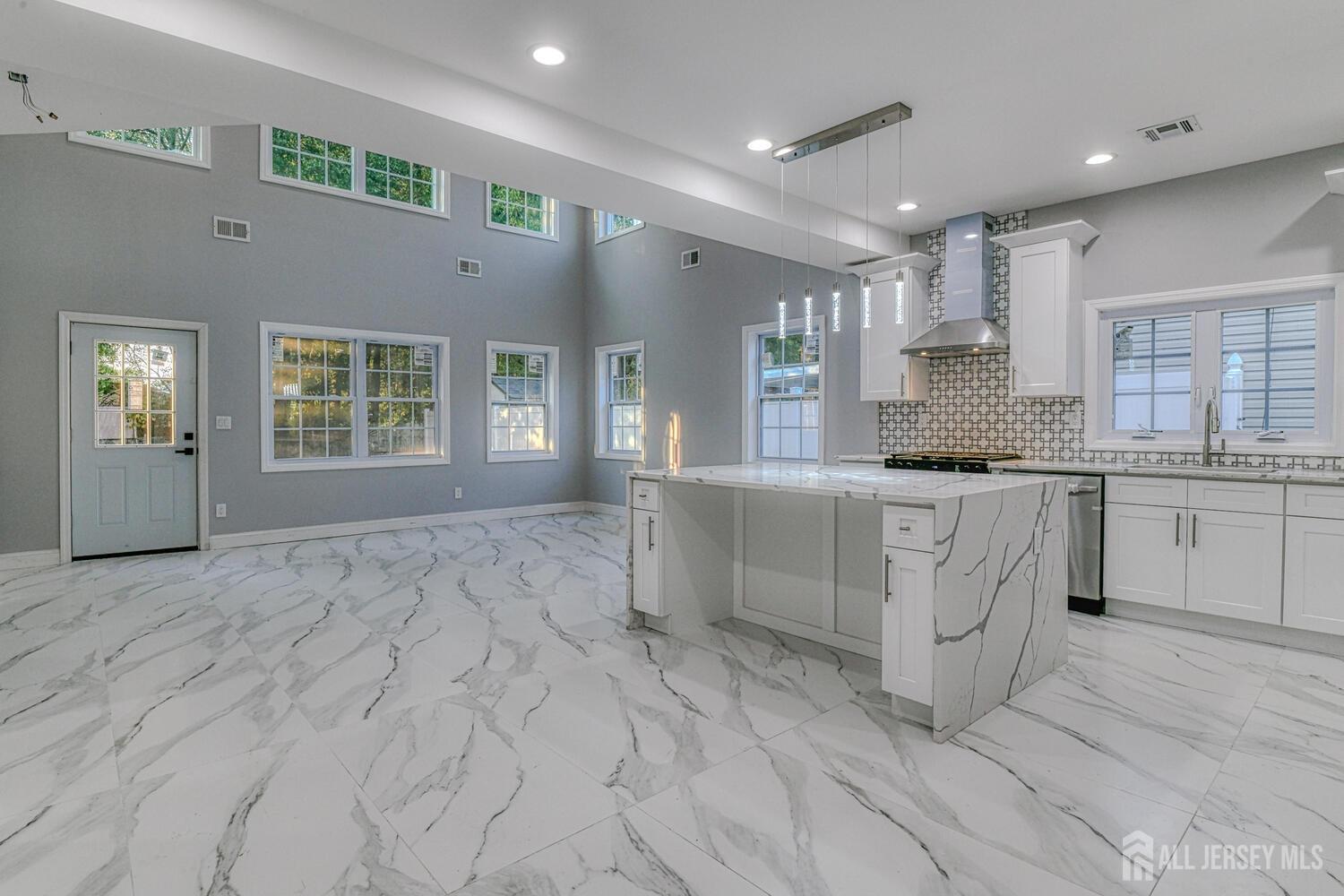 31 Ashley Road Edison, NJ 08817 - Photo 13 of 47 a large kitchen with kitchen island a sink stainless steel appliances and cabinets