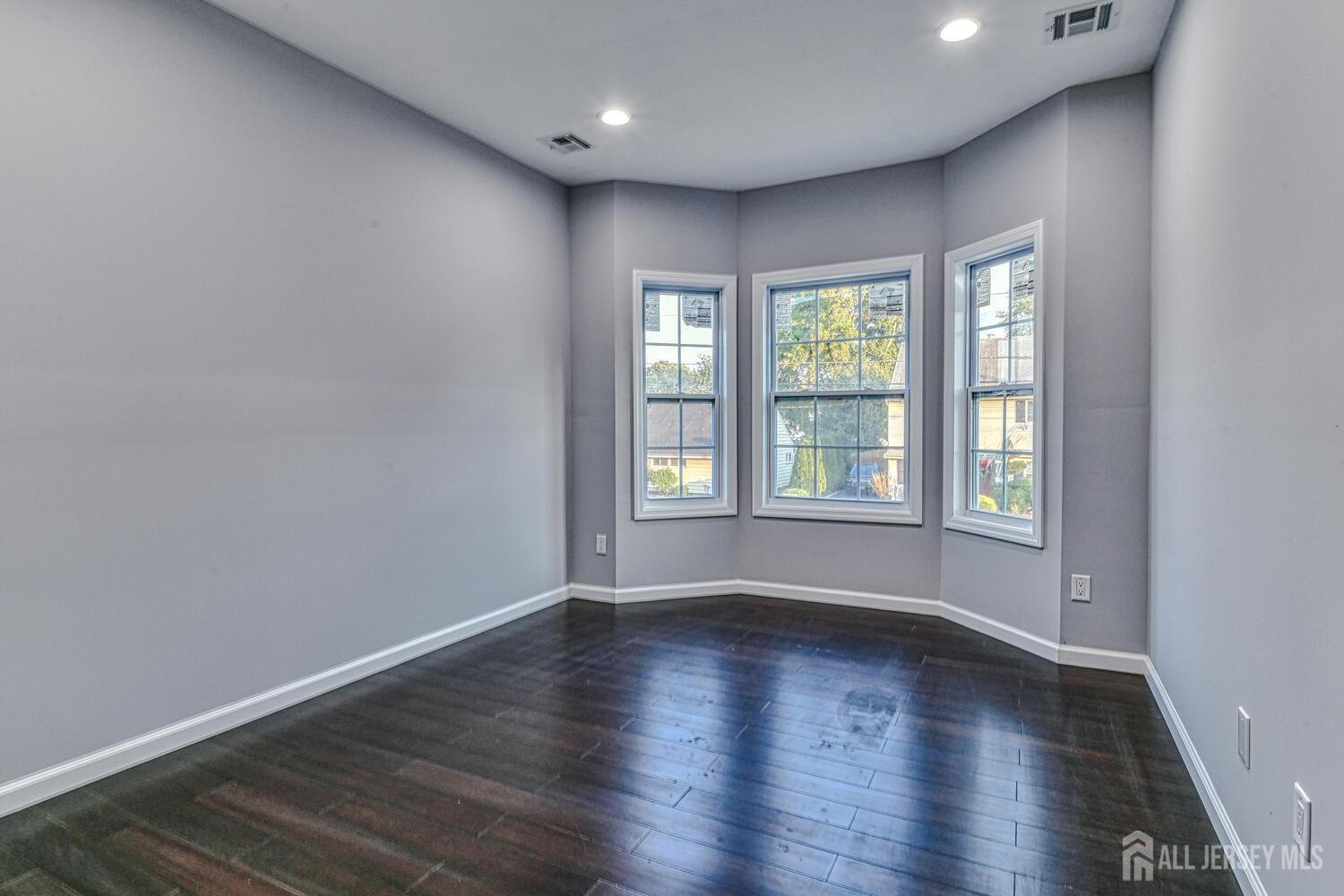 31 Ashley Road Edison, NJ 08817 - Photo 19 of 47 a view of an empty room with wooden floor and a window