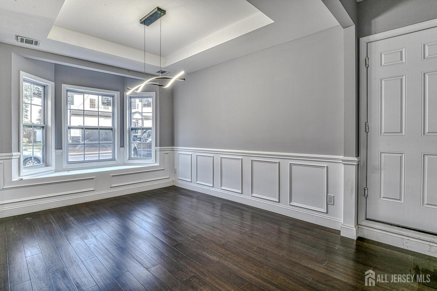 31 Ashley Road Edison, NJ 08817 - Photo 22 of 47 a view of an empty room with wooden floor and a window