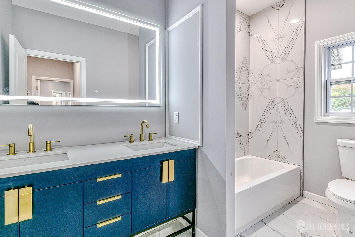 31 Ashley Road Edison, NJ 08817 - Photo 25 of 47 a bathroom with a sink a toilet and shower