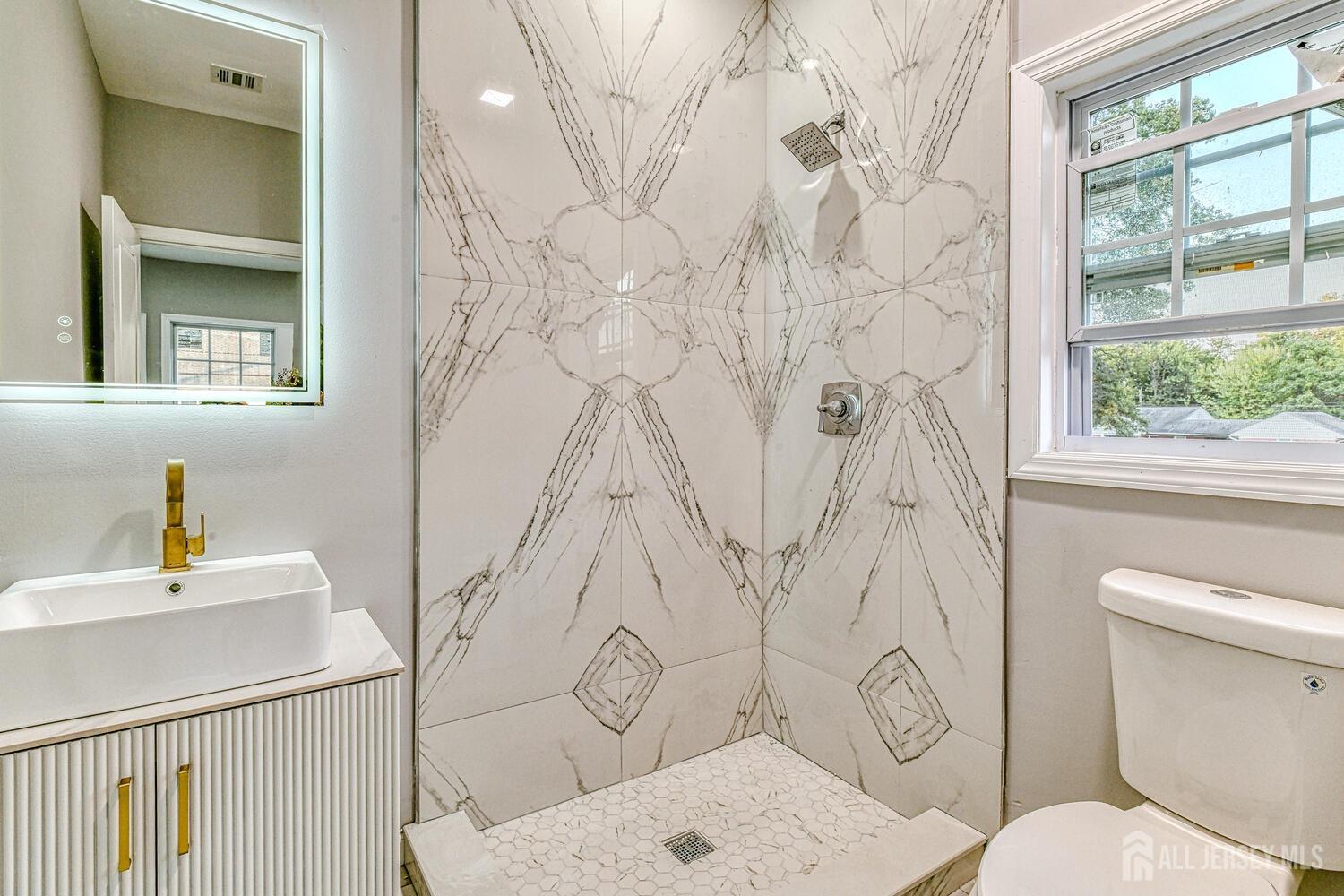 31 Ashley Road Edison, NJ 08817 - Photo 26 of 47 a bathroom with a toilet sink and shower