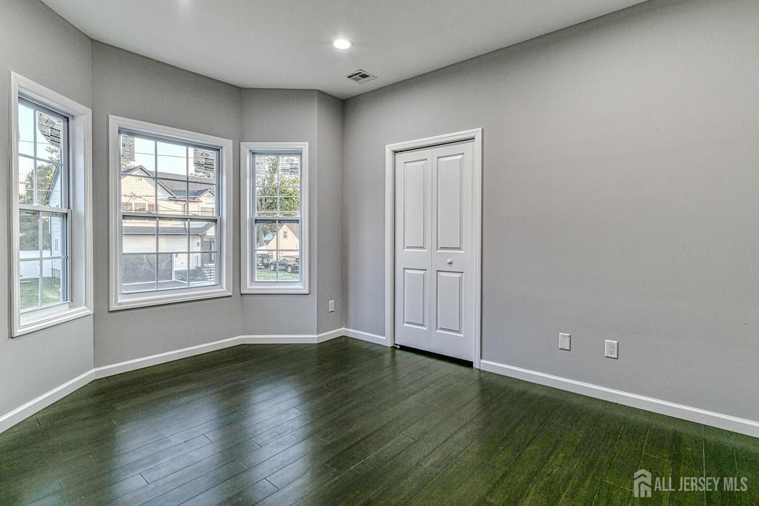31 Ashley Road Edison, NJ 08817 - Photo 27 of 47 a view of an empty room with wooden floor and a window