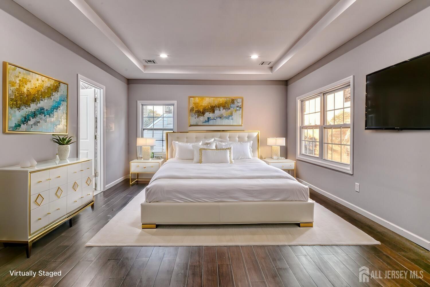 31 Ashley Road Edison, NJ 08817 - Photo 33 of 47 a bedroom with a large bed and a flat tv screen on dresser