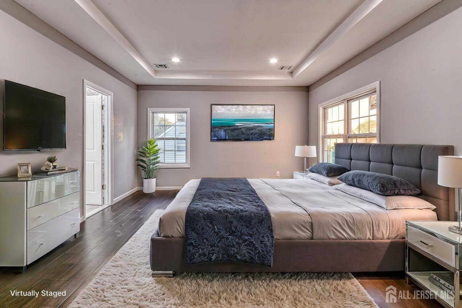 31 Ashley Road Edison, NJ 08817 - Photo 34 of 47 a bedroom with a large bed and a flat screen tv