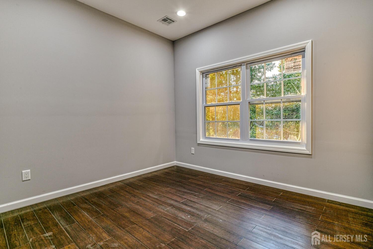 31 Ashley Road Edison, NJ 08817 - Photo 38 of 47 a view of an empty room with wooden floor and a window