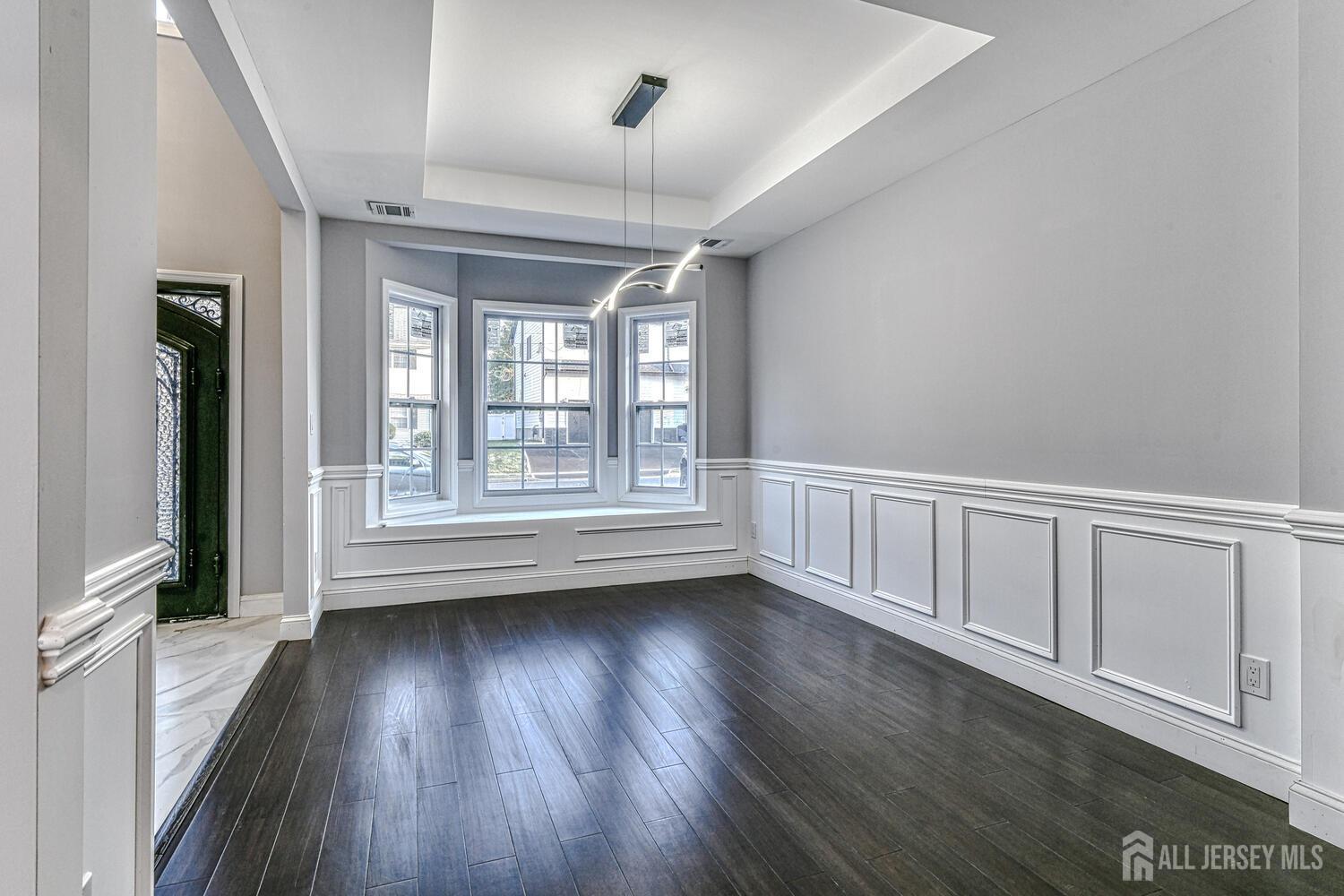 31 Ashley Road Edison, NJ 08817 - Photo 6 of 47 a view of an empty room with wooden floor and a window