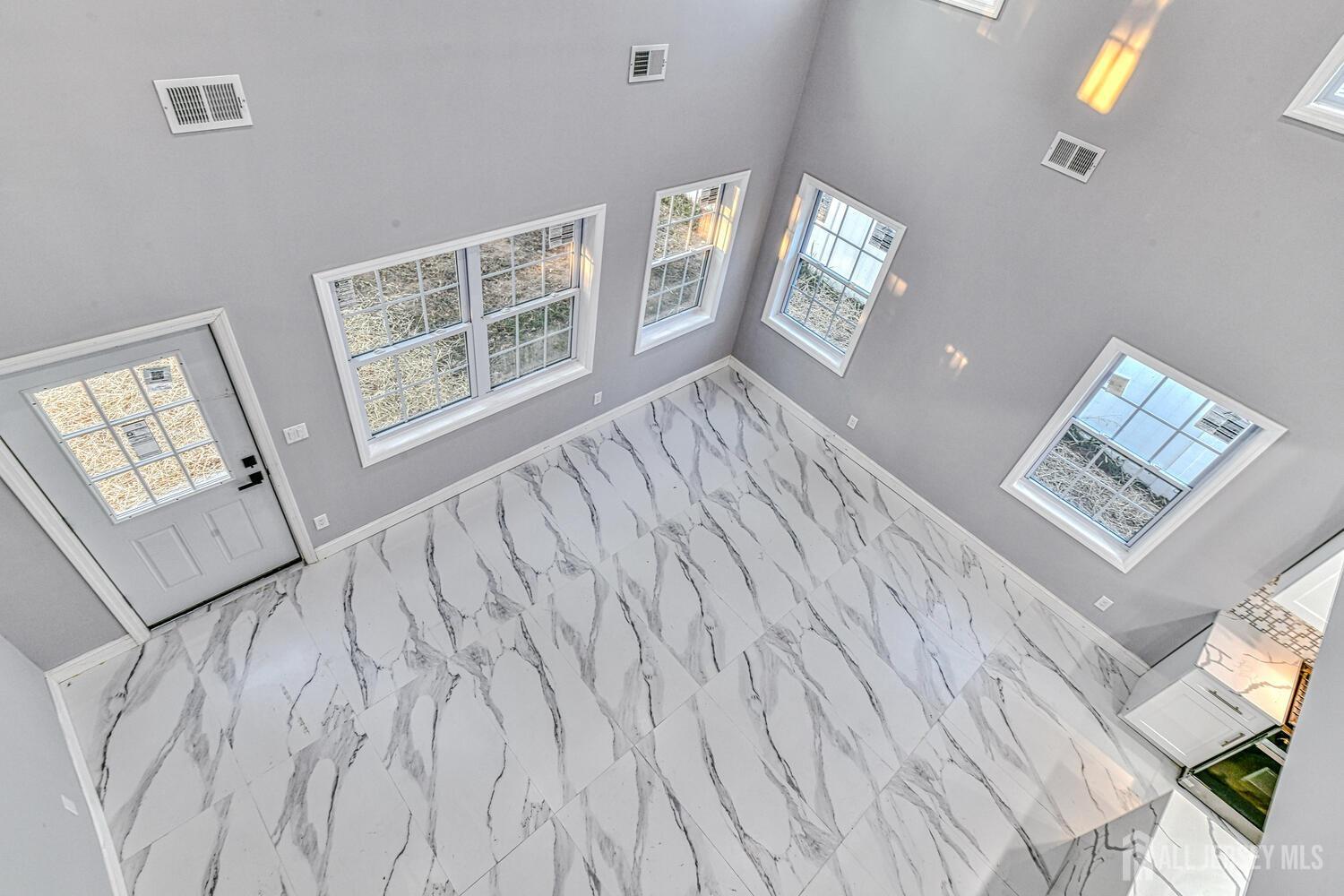 31 Ashley Road Edison, NJ 08817 - Photo 10 of 47 a view of an empty room and window with wooden floor