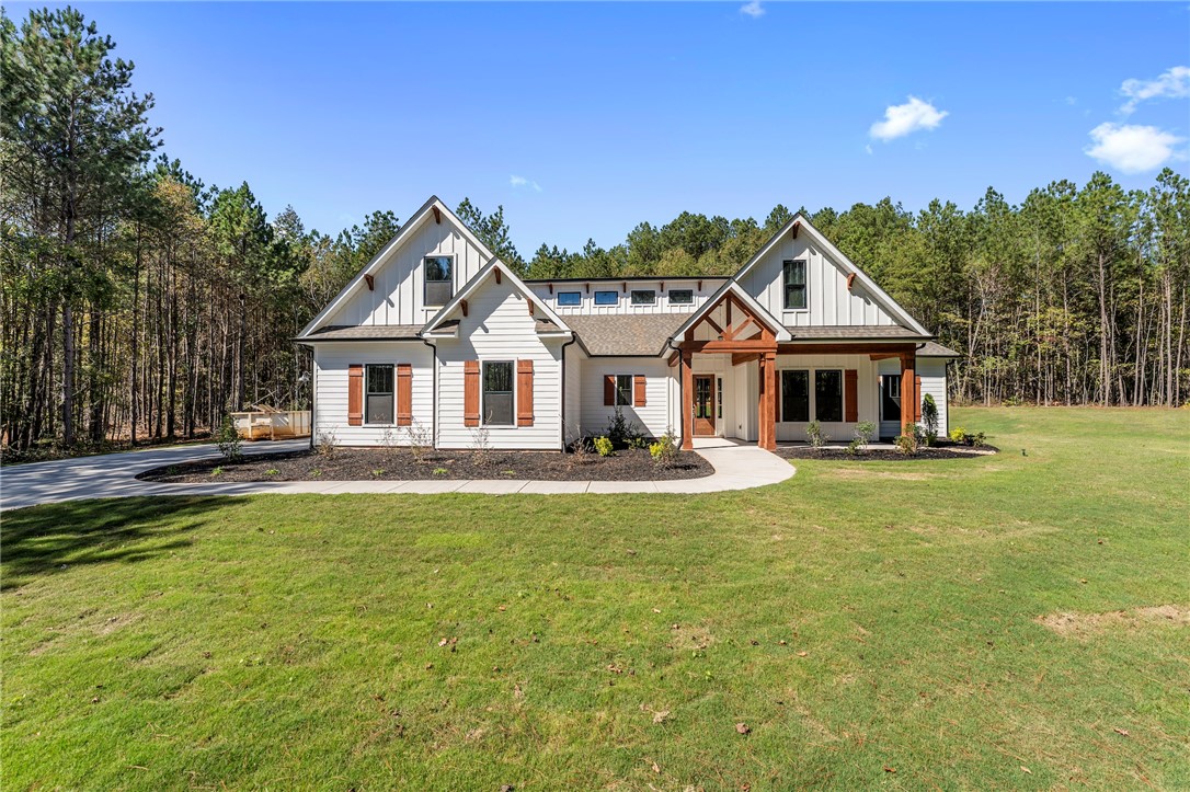1031 Hill Road Anderson, SC 29621 - Photo 1 of 35 A striking modern farmhouse with warm wood accents against crisp white siding.