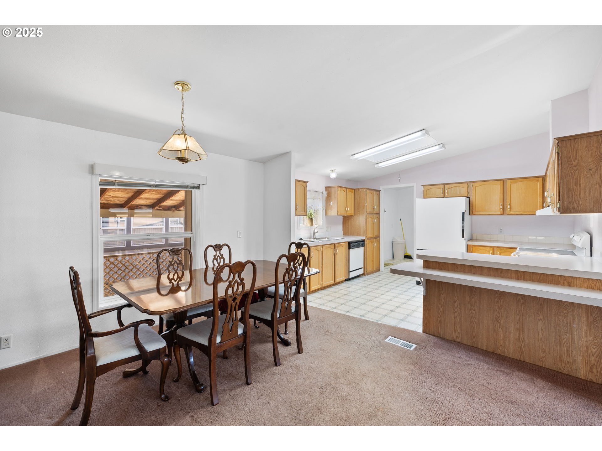 1949 Southeast Palmquist Road, Unit 121 Gresham, OR 97080 - Photo 11 of 37 a view of a dining room with furniture and wooden floor