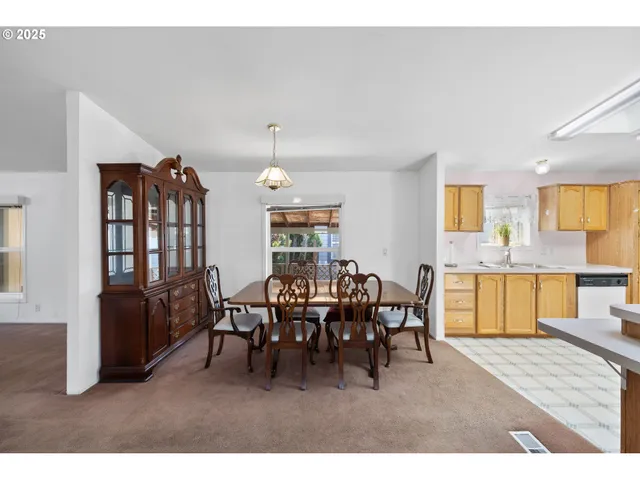 a view of a dining room with furniture and chandelier