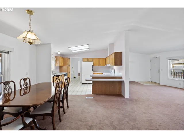 a view of a dining room with furniture and chandelier