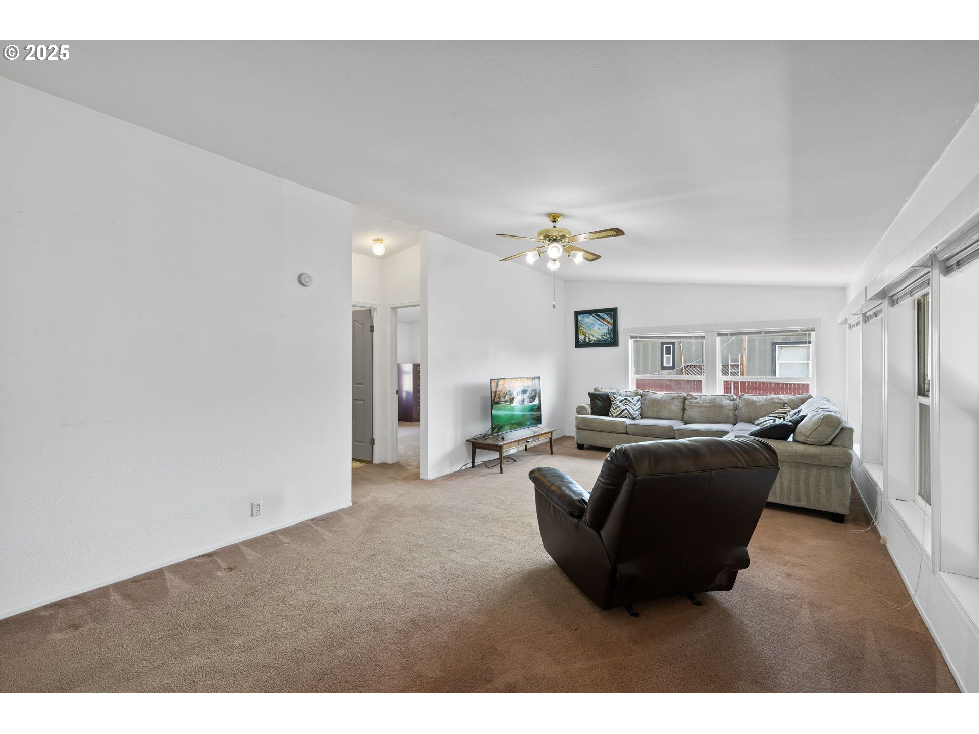 1949 Southeast Palmquist Road, Unit 121 Gresham, OR 97080 - Photo 15 of 37 a living room with furniture and a chandelier