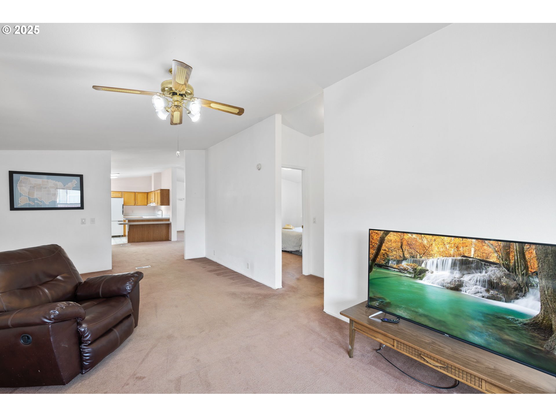 1949 Southeast Palmquist Road, Unit 121 Gresham, OR 97080 - Photo 16 of 37 a living room with furniture and a flat screen tv