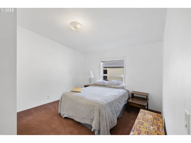 a bedroom with a bed and a night stand