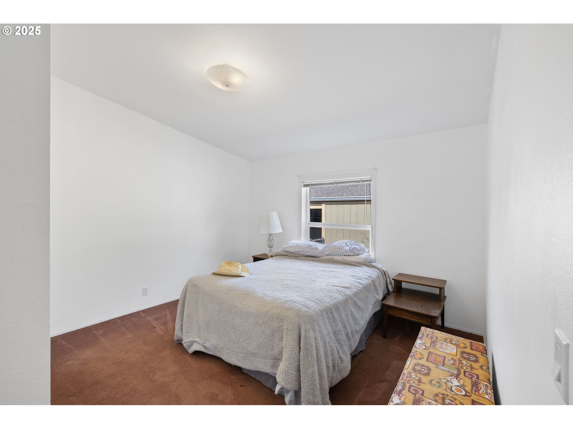 1949 Southeast Palmquist Road, Unit 121 Gresham, OR 97080 - Photo 25 of 37 a bedroom with a bed and a night stand