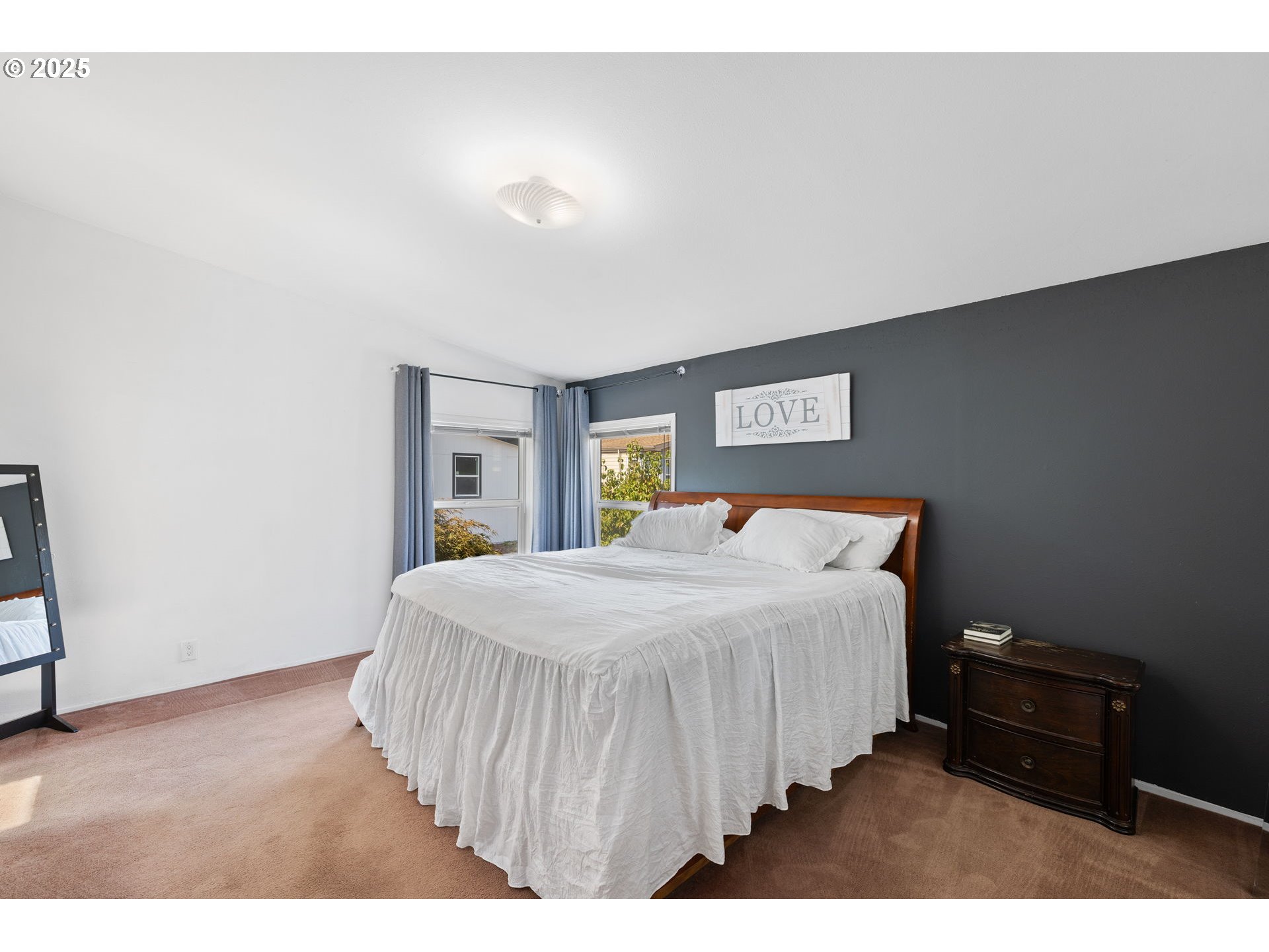 1949 Southeast Palmquist Road, Unit 121 Gresham, OR 97080 - Photo 27 of 37 a bedroom with a bed and a tv