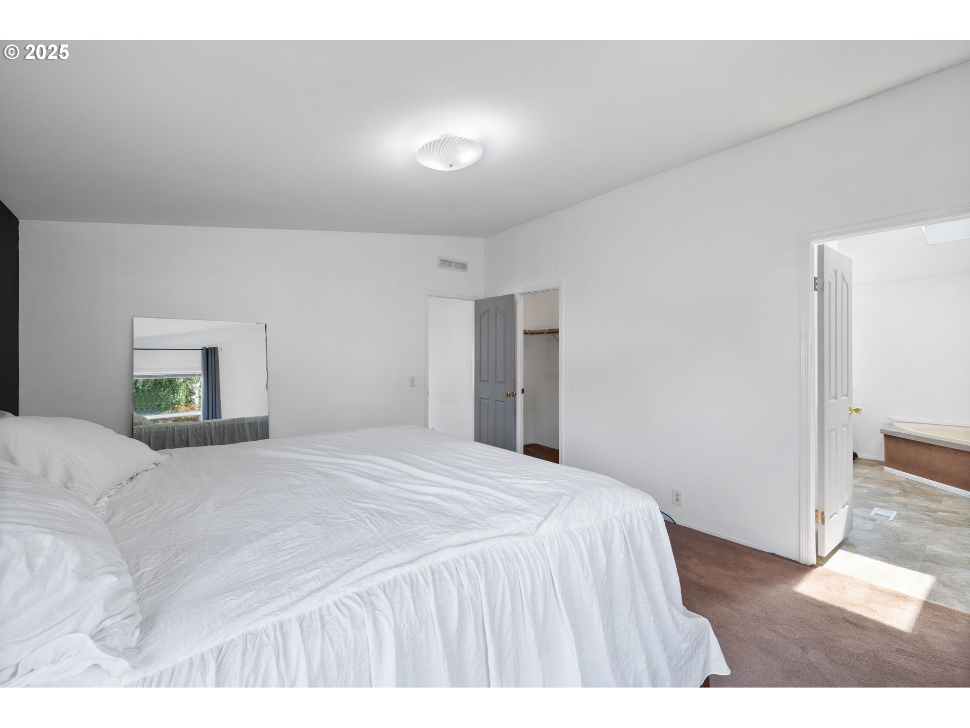 1949 Southeast Palmquist Road, Unit 121 Gresham, OR 97080 - Photo 29 of 37 a bedroom with a bed and a painting on the wall