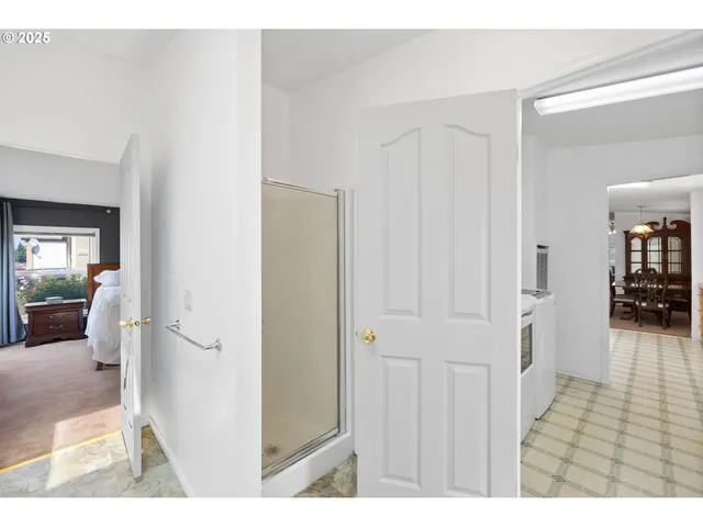 a view of a hallway with wooden floor and furniture