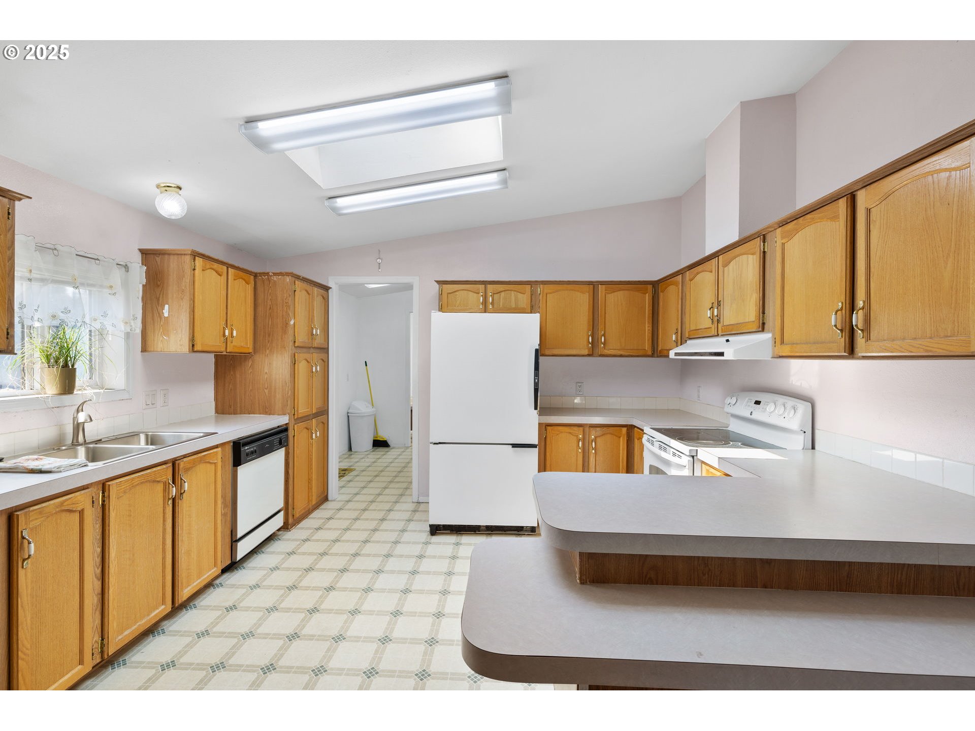 1949 Southeast Palmquist Road, Unit 121 Gresham, OR 97080 - Photo 8 of 37 a kitchen with a sink a stove and cabinets