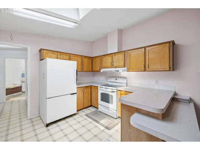 a kitchen with stainless steel appliances a stove a sink and a refrigerator