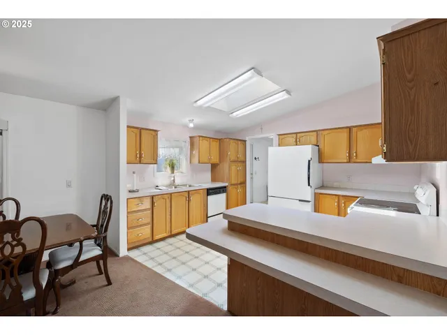 a kitchen with a sink cabinets and window