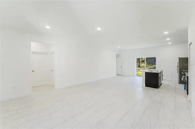 a view of a large kitchen with a sink and a large window