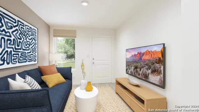 a living room with furniture and a flat screen tv